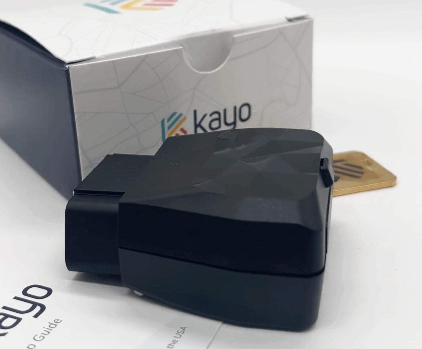 Kayo GPS tracker, box, and key on display.