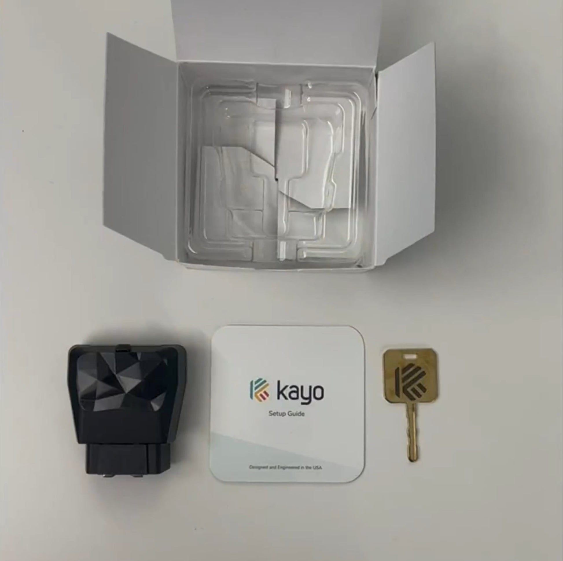 The Kayo GPS tracker, key, and setup guide, unboxed.