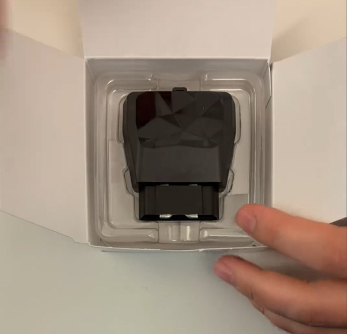 The Kayo GPS tracker displayed in its box.