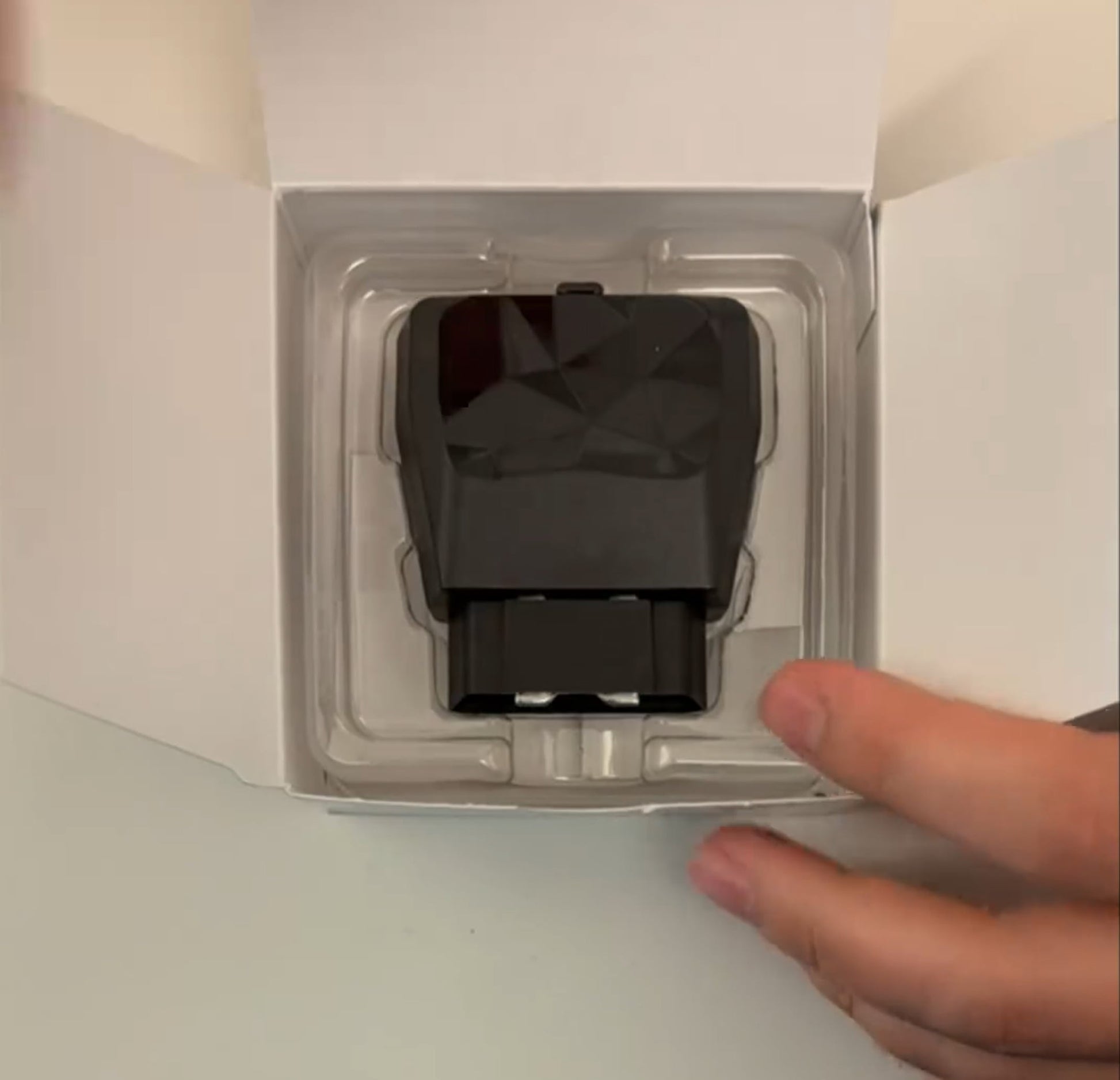 The Kayo GPS tracker displayed in its box.